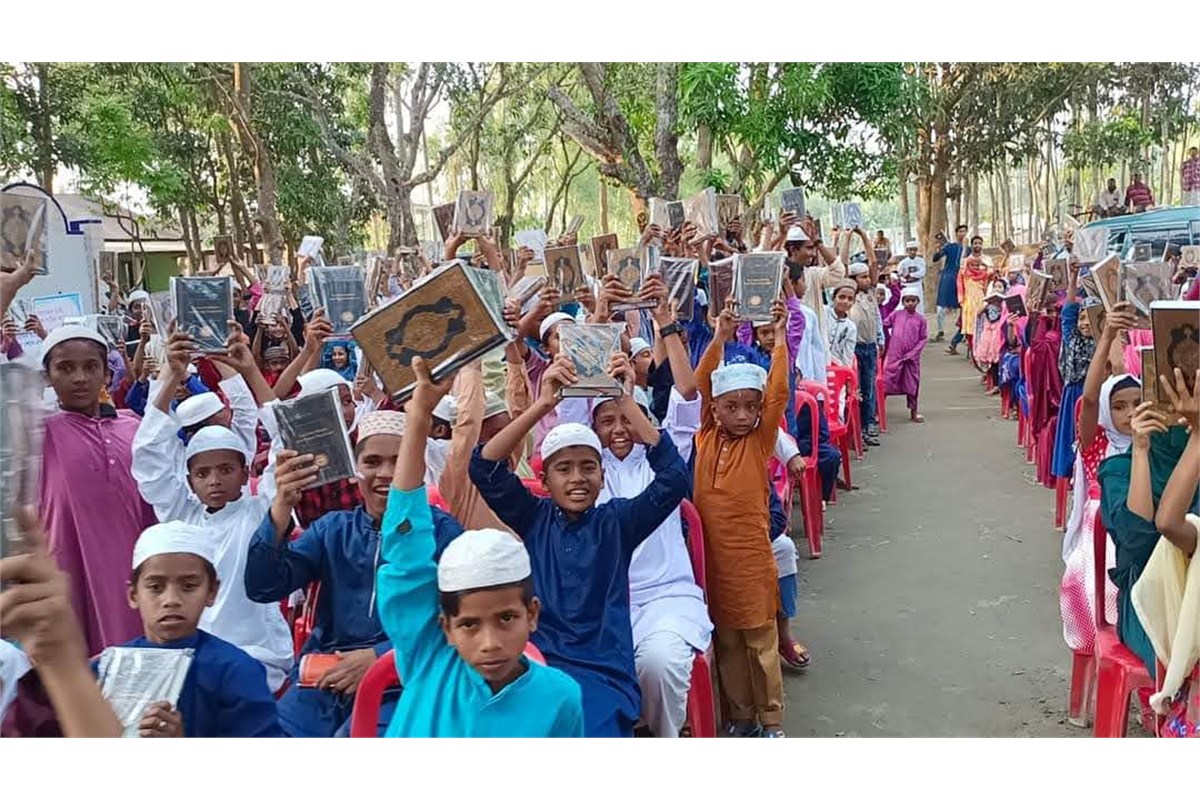 Students receiving Mushafs during distribution